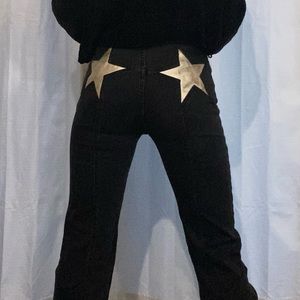 Free people dark grey flared jeans with silver star patching on the butt